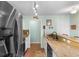 Well-lit kitchen with stainless steel refrigerator and granite countertops at 425 Mallard Lake Circle, Surfside Beach, SC 29575