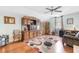 Living room with hardwood floors, ceiling fan, and large decorative shelving unit at 425 Mallard Lake Circle, Surfside Beach, SC 29575