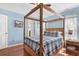 Comfortable main bedroom with a four poster bamboo bed and hardwood floors at 425 Mallard Lake Circle, Surfside Beach, SC 29575