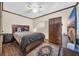 Cozy bedroom with ceiling fan, wood floors and a comfortable bed at 4350 Intercoastal Dr. # 2402, Little River, SC 29566