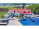 Exterior view of the building with a red roof and a blue car in the parking lot at 4350 Intercoastal Dr. # 2402, Little River, SC 29566