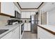Charming kitchen featuring white cabinets, modern appliances, and tile flooring at 4350 Intercoastal Dr. # 2402, Little River, SC 29566