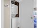 Compact laundry room with stacked washer and dryer at 4350 Intercoastal Dr. # 2402, Little River, SC 29566