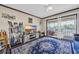 Light-filled living room features a large area rug and a sliding glass door to the screened-in porch at 4350 Intercoastal Dr. # 2402, Little River, SC 29566