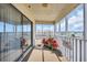 View of the screened porch featuring red flowers and a sliding glass door that leads into the living room at 4350 Intercoastal Dr. # 2402, Little River, SC 29566