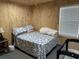 Bedroom featuring a blue and white patterned comforter, window, and baby bassinet at 445 W Willow Pond Rd., Johnsonville, SC 29555