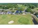 Aerial view of golf course with clubhouse, driving range, and surrounding greenery at 4450 Turtle Ln. # 2-A, Little River, SC 29566