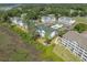 An aerial view of condominiums nestled among trees, a pool, and golf course landscaping at 4450 Turtle Ln. # 2-A, Little River, SC 29566