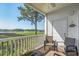 A serene balcony with seating and views of a peaceful waterway and lush surroundings at 4450 Turtle Ln. # 2-A, Little River, SC 29566