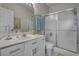Bathroom with a sink, shower, white cabinets, and ample lighting at 4450 Turtle Ln. # 2-A, Little River, SC 29566