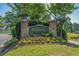 Community sign for The Moorings surrounded by flowers, greenery, and manicured lawn at 4450 Turtle Ln. # 2-A, Little River, SC 29566