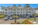 Three story condo with multiple balconies overlooking parking lot and distant waterway views at 4450 Turtle Ln. # 2-A, Little River, SC 29566