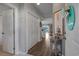 Hallway with white walls, wood floors, and decorated with coastal-themed art at 4450 Turtle Ln. # 2-A, Little River, SC 29566