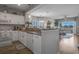 Open kitchen featuring white cabinets, granite countertops, and view to the living area at 4450 Turtle Ln. # 2-A, Little River, SC 29566
