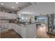 Open kitchen concept with granite countertops and view into living and dining areas at 4450 Turtle Ln. # 2-A, Little River, SC 29566