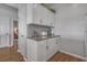A kitchenette featuring white cabinets and granite countertops with stainless steel hardware at 4450 Turtle Ln. # 2-A, Little River, SC 29566