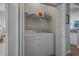 A laundry area featuring a washer and dryer set with storage shelves above, inside of a closet at 4450 Turtle Ln. # 2-A, Little River, SC 29566