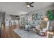 Open-concept living room with modern furnishings, ceiling fan, and wood floors at 4450 Turtle Ln. # 2-A, Little River, SC 29566