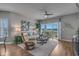 A comfortable living room with recliners, a sofa, and a sliding glass door to a balcony overlooking a serene view at 4450 Turtle Ln. # 2-A, Little River, SC 29566