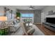 Living room with plush seating, wood floors, and a view of the water at 4450 Turtle Ln. # 2-A, Little River, SC 29566