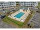 Aerial view of community pool with surrounding lounge chairs and landscaped greenery, perfect for relaxation at 4450 Turtle Ln. # 2-A, Little River, SC 29566
