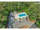Aerial view of resort-style pool, clubhouse, and ample parking nestled within a lush green landscape at 4450 Turtle Ln. # 2-A, Little River, SC 29566
