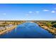 Aerial view of a waterway with properties on either side and a lighthouse in the distance at 4520 Coquina Harbour Dr. # F-3, Little River, SC 29566