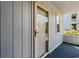 Cozy condo entrance features a screen door and wood-panel siding with a view of landscaping at 4520 Coquina Harbour Dr. # F-3, Little River, SC 29566