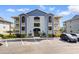 Charming condo building with classic design, well-kept landscaping, and ample parking space for residents and guests at 4520 Coquina Harbour Dr. # F-3, Little River, SC 29566