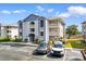 Inviting condominium building with traditional design, outdoor balconies, and well-maintained parking at 4520 Coquina Harbour Dr. # F-3, Little River, SC 29566