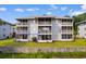 Exterior of unit F3 with a screened patio and nice curb appeal overlooking well-maintained landscaping at 4520 Coquina Harbour Dr. # F-3, Little River, SC 29566