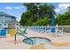 Community hot tub and seating area, alongside the pool with lounge chairs and umbrellas at 4520 Coquina Harbour Dr. # F-3, Little River, SC 29566