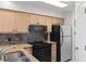 Modern kitchen featuring stainless appliances, tile backsplash, granite countertops, and ample cabinet space at 4520 Coquina Harbour Dr. # F-3, Little River, SC 29566