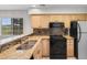 Well-equipped kitchen with granite countertops, ample cabinet space, and a window overlooking the deck at 4520 Coquina Harbour Dr. # F-3, Little River, SC 29566