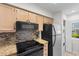 Well-equipped kitchen featuring sleek black appliances and stylish backsplash at 4520 Coquina Harbour Dr. # F-3, Little River, SC 29566