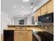 Open-concept kitchen features granite countertops, updated appliances, and a view of the outdoor marsh at 4520 Coquina Harbour Dr. # F-3, Little River, SC 29566