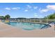 Community outdoor pool with plenty of lounge chairs surrounded by a white fence at 4520 Coquina Harbour Dr. # F-3, Little River, SC 29566
