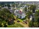 Aerial shot of condos nestled in trees, near a lake, featuring a community pool at 4940 Windsor Green Way # 301, Myrtle Beach, SC 29579