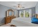 Well-lit bedroom features a large window, wooden dresser, and cozy ambiance for restful nights at 4940 Windsor Green Way # 301, Myrtle Beach, SC 29579