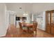 Charming dining area featuring hardwood floors, a wooden table, and access to the kitchen at 4940 Windsor Green Way # 301, Myrtle Beach, SC 29579