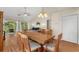 Open-concept dining area featuring wood table, seating for six, and balcony access for bright natural light at 4940 Windsor Green Way # 301, Myrtle Beach, SC 29579
