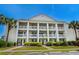 Inviting condo exterior featuring multiple balconies, lush landscaping at 4940 Windsor Green Way # 301, Myrtle Beach, SC 29579