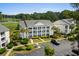 Scenic view of condos near a golf course, featuring lush landscaping and parking at 4940 Windsor Green Way # 301, Myrtle Beach, SC 29579