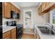 Well-lit kitchen featuring modern appliances, wooden cabinetry, and plenty of counter space at 4940 Windsor Green Way # 301, Myrtle Beach, SC 29579