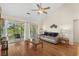 Comfortable living room boasting hardwood floors, vaulted ceilings, and sliding glass doors to the balcony at 4940 Windsor Green Way # 301, Myrtle Beach, SC 29579