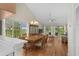Bright living room with vaulted ceilings, hardwood floors, and large windows with golf course views at 4940 Windsor Green Way # 301, Myrtle Beach, SC 29579