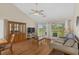 Cozy living room featuring hardwood floors, vaulted ceilings, and access to the outdoor balcony at 4940 Windsor Green Way # 301, Myrtle Beach, SC 29579