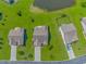 Aerial view of neighborhood homes with well-kept lawns, driveways, and landscaping showcasing community layout at 5 Coffee Mill Creek Ln., Carolina Shores, NC 28467