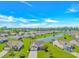 Expansive aerial view of a residential community with a central lake and well-maintained landscaping at 5 Coffee Mill Creek Ln., Carolina Shores, NC 28467