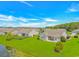 Aerial view of homes in a beautiful community with pond and green lawns at 5 Coffee Mill Creek Ln., Carolina Shores, NC 28467